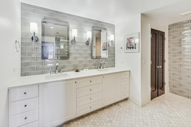 full bathroom featuring double vanity, tile walls, backsplash, and a sink