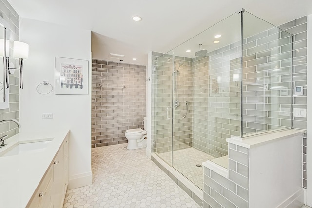 bathroom with recessed lighting, a stall shower, toilet, and vanity