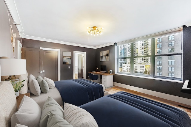 bedroom featuring baseboards and wood finished floors