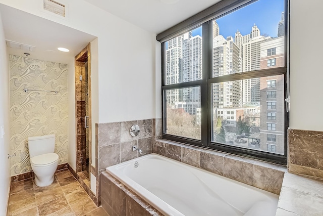 full bathroom featuring a wealth of natural light, visible vents, a view of city, and toilet