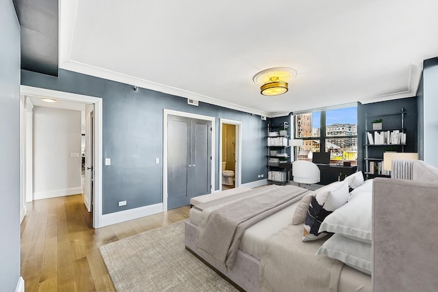 bedroom with light wood-type flooring and baseboards