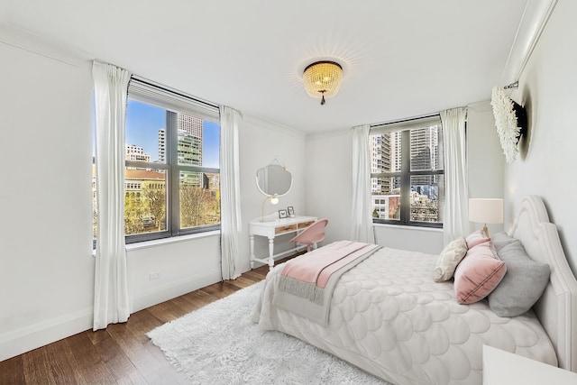 bedroom with wood finished floors and baseboards