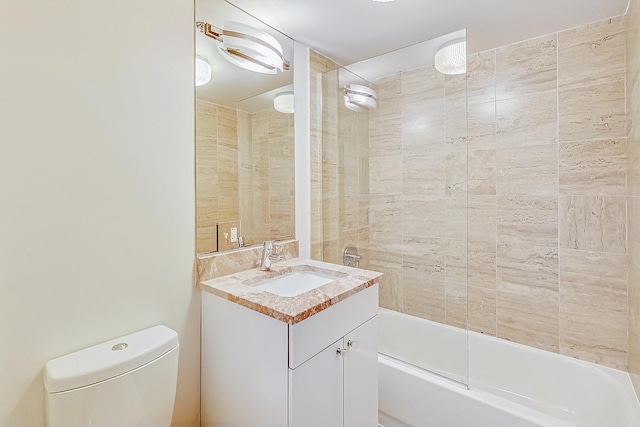 bathroom with tub / shower combination, toilet, and vanity