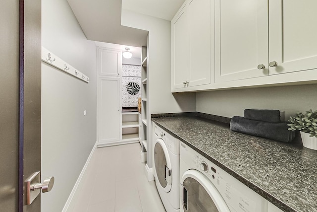 laundry room with cabinet space, light tile patterned floors, separate washer and dryer, and baseboards