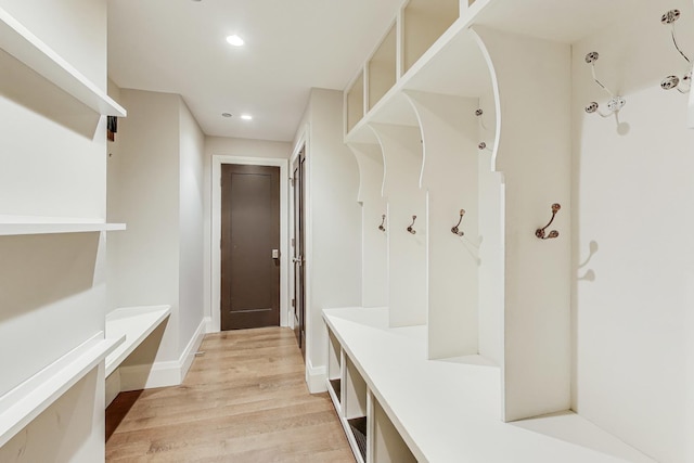 mudroom with recessed lighting, light wood-type flooring, and baseboards