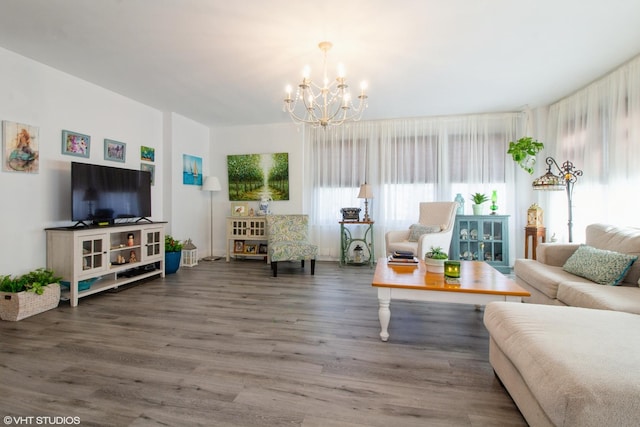 living area with a chandelier and wood finished floors