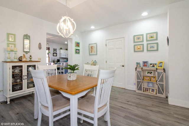 dining space featuring a chandelier, wood finished floors, and recessed lighting