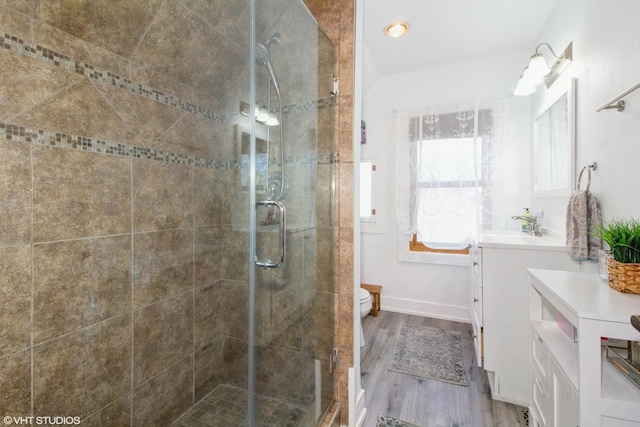 full bath with baseboards, toilet, wood finished floors, vanity, and a shower stall