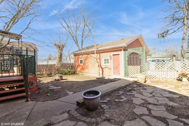 exterior space with an outbuilding and fence