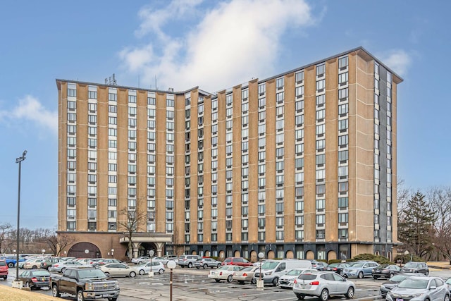 view of building exterior with uncovered parking