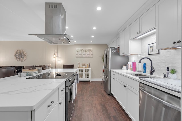 kitchen with a sink, white cabinets, open floor plan, appliances with stainless steel finishes, and island exhaust hood