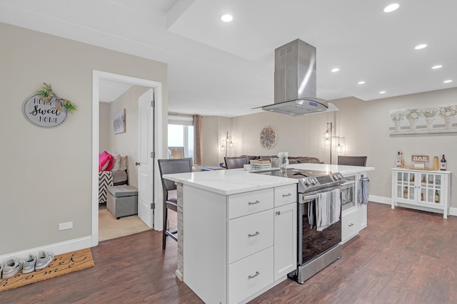 kitchen with dark wood-style floors, a center island, electric stove, white cabinetry, and island range hood