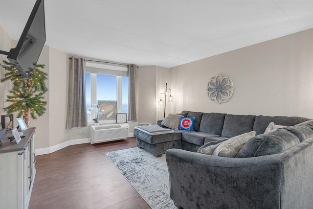 living area with dark wood-style flooring and baseboards