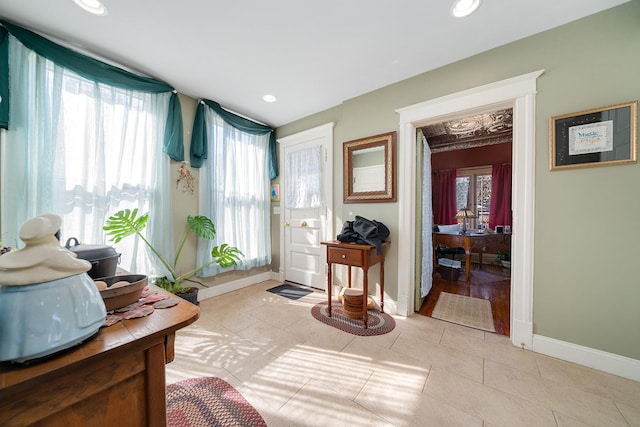 sitting room featuring light tile patterned flooring, baseboards, a wealth of natural light, and recessed lighting