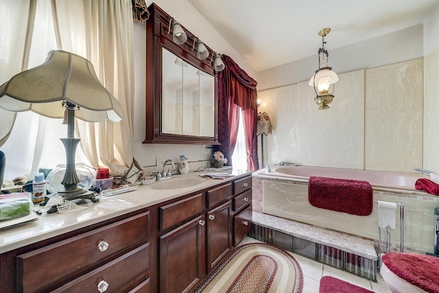 full bath with toilet, vanity, a bath, and tile patterned floors