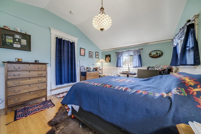 bedroom with lofted ceiling and wood finished floors