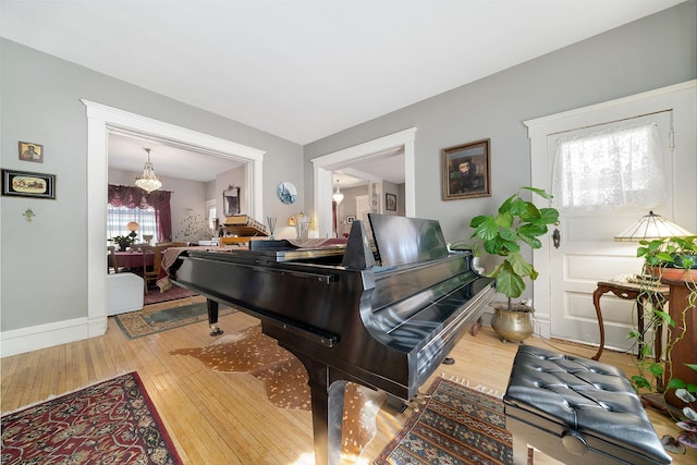 living area featuring wood-type flooring and baseboards