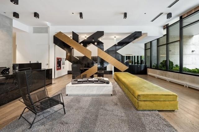 building lobby featuring visible vents and stairs