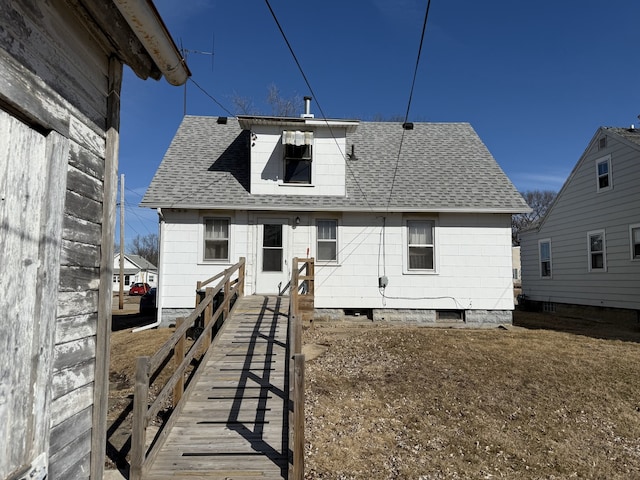 back of property with a shingled roof