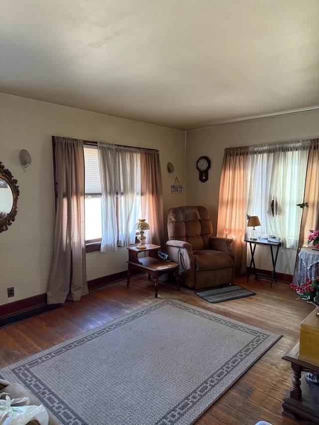 living room featuring baseboards and wood finished floors