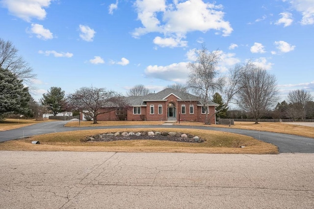 view of front facade with aphalt driveway and brick siding