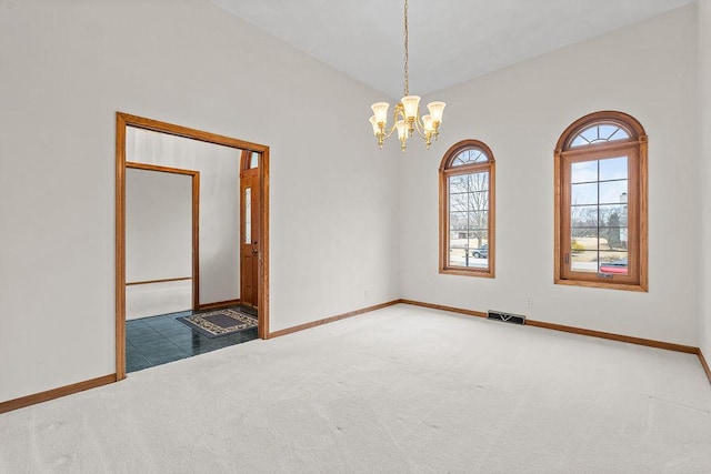 spare room featuring a chandelier, carpet flooring, visible vents, and baseboards