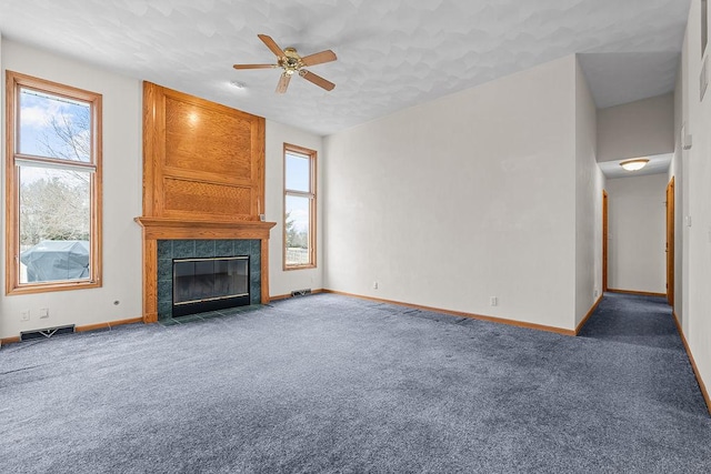 unfurnished living room with carpet, visible vents, a fireplace, and baseboards