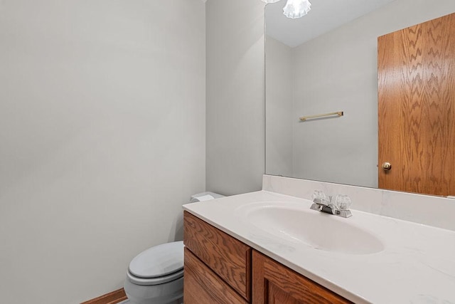 half bath featuring toilet and vanity