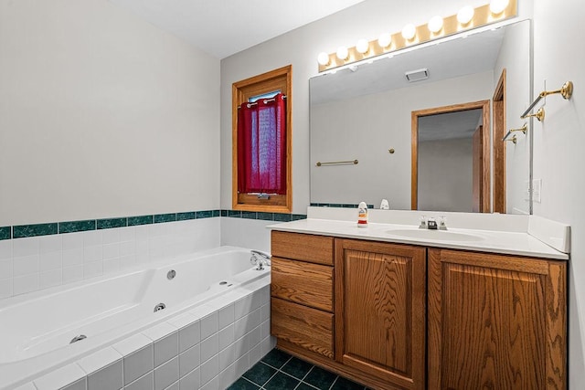 bathroom featuring a jetted tub, vanity, visible vents, and tile patterned floors