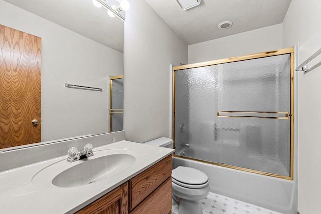 full bathroom featuring combined bath / shower with glass door, vanity, and toilet