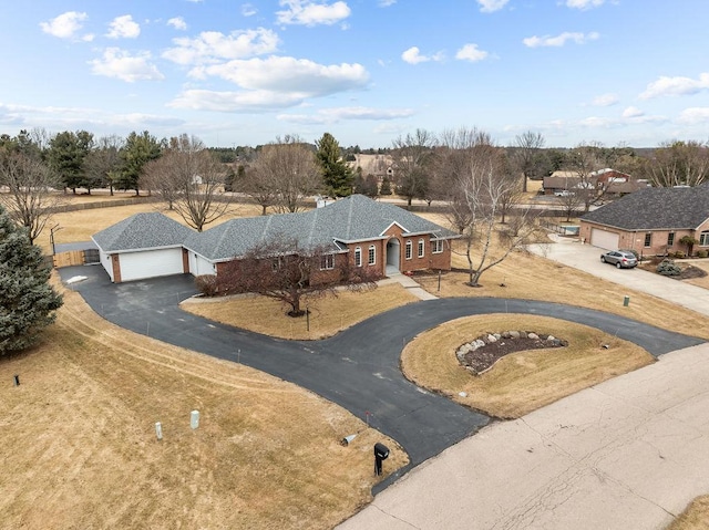 ranch-style home with driveway and an attached garage