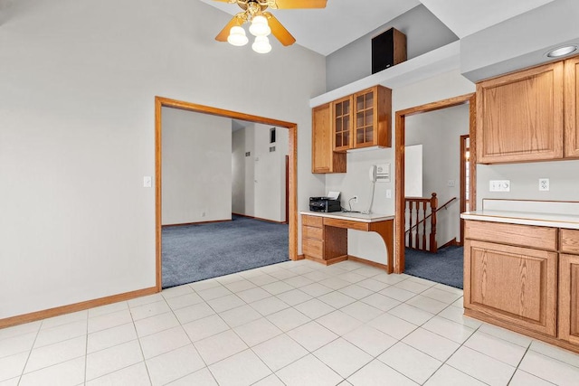 kitchen featuring light carpet, light countertops, and built in study area