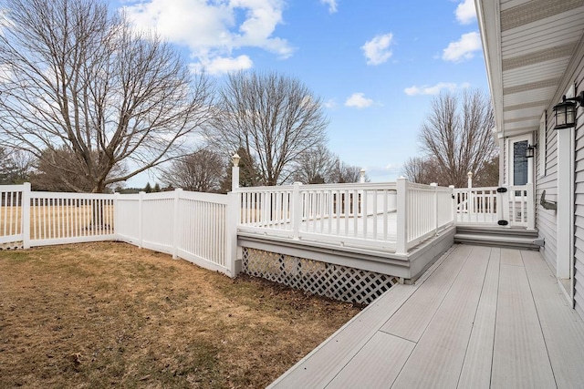 wooden terrace featuring a yard and fence