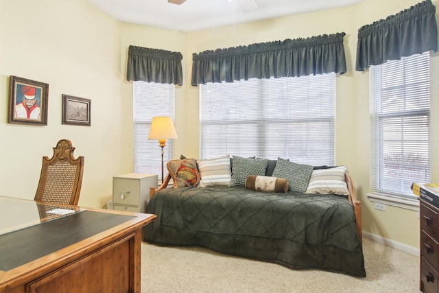 bedroom with ceiling fan and baseboards