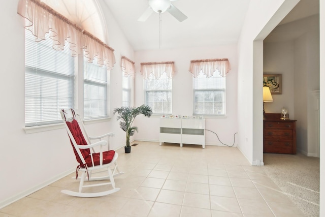 sitting room featuring lofted ceiling, ceiling fan, tile patterned flooring, and a wealth of natural light