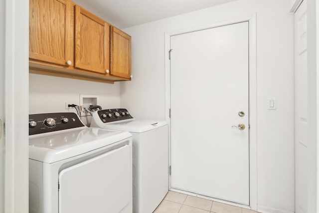 laundry area featuring cabinet space, independent washer and dryer, and light tile patterned flooring