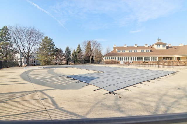 community pool with fence and a patio