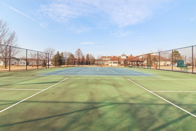 view of tennis court featuring fence