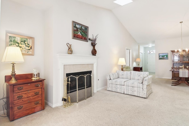 living room featuring lofted ceiling, a chandelier, a tile fireplace, baseboards, and carpet