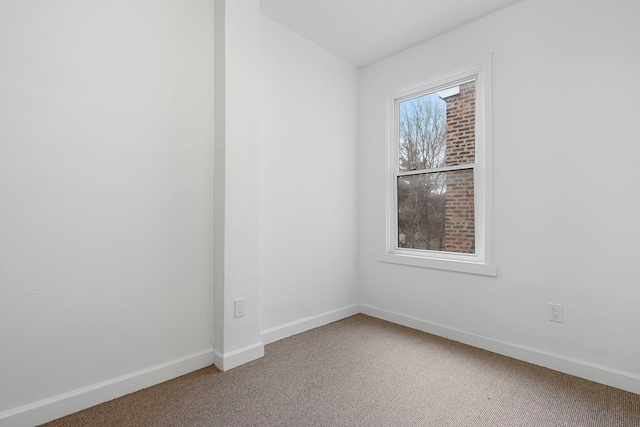 unfurnished room with light carpet and baseboards