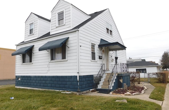 cape cod house featuring fence