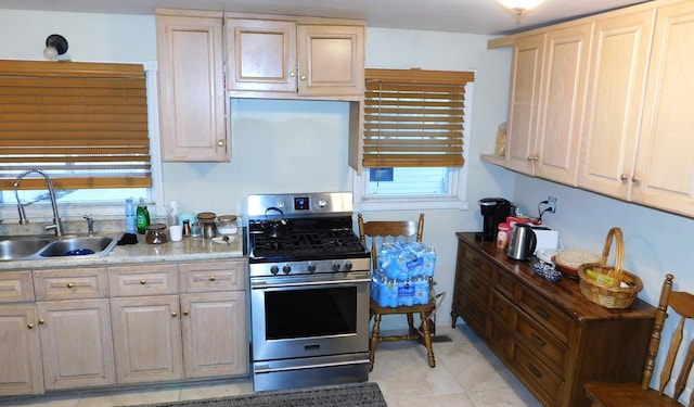 kitchen with light countertops, a sink, and gas range