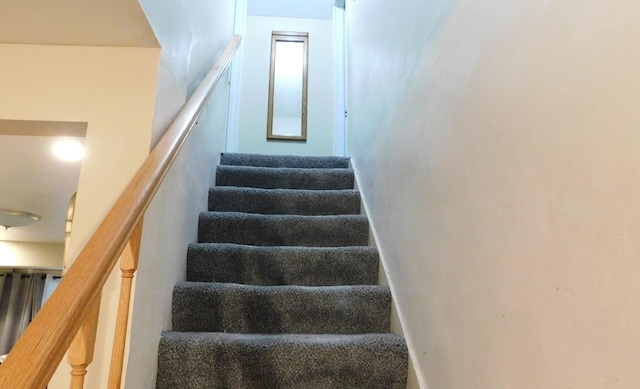 staircase featuring baseboards