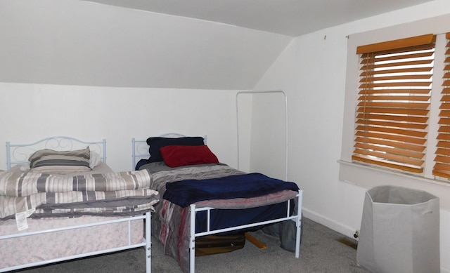 bedroom with carpet, vaulted ceiling, and baseboards