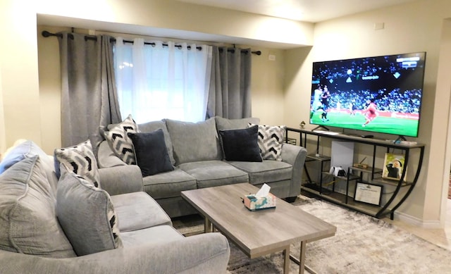 living area featuring baseboards