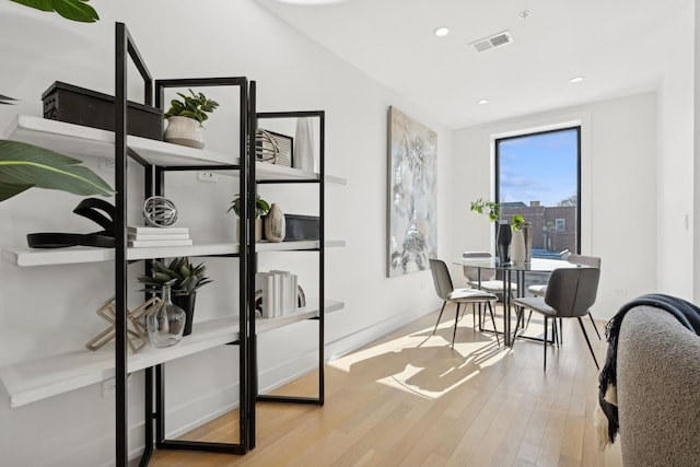 home office with recessed lighting, visible vents, baseboards, and wood finished floors