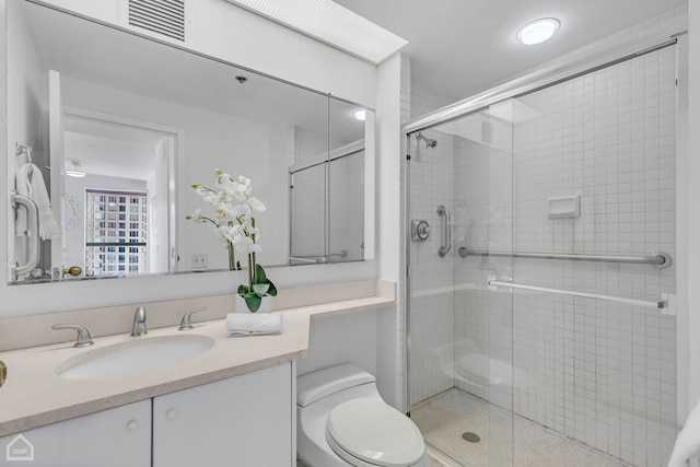 full bathroom with a stall shower, vanity, and toilet