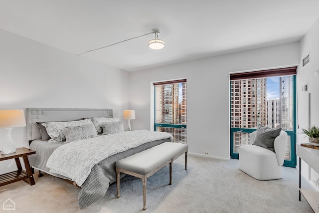 bedroom with carpet, visible vents, and baseboards