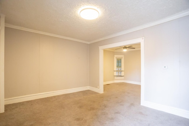 empty room with baseboards, a textured ceiling, ornamental molding, and carpet flooring