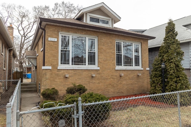 view of side of home with brick siding and a fenced backyard